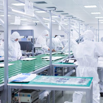 people in white isolating costumes working in laboratory