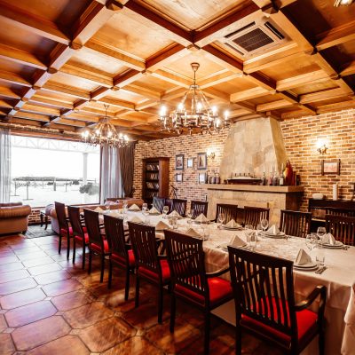 restaurant private room with table for 14 persons wooden ceiling brick walls and fireplace